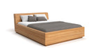Designer Holzbett Calveno aus massiver Eiche mit Stauraum und geneigtem Headboard